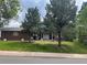Charming brick home with manicured lawn, mature trees, and a welcoming front porch at 1158 E Easter Ct, Centennial, CO 80122