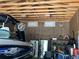 Garage interior featuring boat, refrigerator, workbench and storage shelves at 1158 E Easter Ct, Centennial, CO 80122