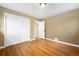 Bedroom featuring hardwood floors, neutral walls, and a closet with white folding doors at 3960 Cody St, Wheat Ridge, CO 80033