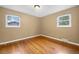 Bedroom featuring hardwood floors, neutral walls, and two sunlit windows at 3960 Cody St, Wheat Ridge, CO 80033