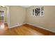 Empty bedroom featuring hardwood floors, neutral walls, and a sunlit window at 3960 Cody St, Wheat Ridge, CO 80033