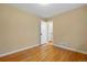 Bedroom with hardwood floors, a window, and a closet with white folding doors at 3960 Cody St, Wheat Ridge, CO 80033