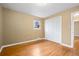 Bedroom featuring hardwood floors, a window, and a closet with white folding doors at 3960 Cody St, Wheat Ridge, CO 80033
