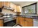 Kitchen featuring wood cabinets, stainless steel appliances, and a window above the sink at 3960 Cody St, Wheat Ridge, CO 80033