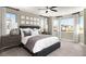 Calming bedroom with neutral tones, a ceiling fan, large windows, and a comfortable bed at 9192 Telluride Ct, Commerce City, CO 80022
