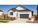 Charming home featuring a two-car garage, neutral colors, and a well-manicured front yard at 9192 Telluride Ct, Commerce City, CO 80022