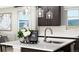 Bright kitchen island with white countertop, stainless steel faucet, and stylish pendant lighting at 9192 Telluride Ct, Commerce City, CO 80022