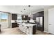 Modern kitchen features a large island with pendant lighting, stainless steel appliances, and dark cabinets at 9192 Telluride Ct, Commerce City, CO 80022
