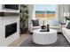 Bright living room with a fireplace, large window, and a white round coffee table at 9192 Telluride Ct, Commerce City, CO 80022