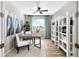 Bright and airy home office featuring neutral tones, open shelving, and a large window at 9192 Telluride Ct, Commerce City, CO 80022
