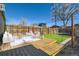 Outdoor patio with wooden deck, artificial turf, and stylish furniture at 3726 N High St, Denver, CO 80205