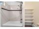 Bright bathroom with a shower-tub combination and built-in shelving at 3726 N High St, Denver, CO 80205