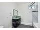 Bathroom featuring dark vanity, glass vessel sink, mosaic backsplash, and a shower/tub combination at 3726 N High St, Denver, CO 80205