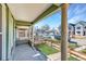 Inviting front porch with beautiful pillars offers a charming view of the neighborhood street at 3726 N High St, Denver, CO 80205