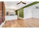 Open concept living space with hardwood floors and exposed brick accent wall at 3726 N High St, Denver, CO 80205