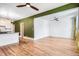 Spacious living room with hardwood floors leading into a renovated kitchen at 3726 N High St, Denver, CO 80205
