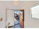 A mud room with white walls, tile floors, and a door leading to a deck and backyard at 3726 N High St, Denver, CO 80205