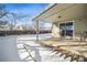 Backyard with a wooden deck and snowy landscape at 6663 Zinnia St, Arvada, CO 80004