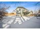 View of house from backyard, snowy landscape at 6663 Zinnia St, Arvada, CO 80004