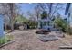 Expansive backyard with outdoor kitchen, garden beds, and mature trees at 7761 S Wellington St, Centennial, CO 80122