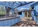 Backyard deck with outdoor kitchen, patio, and arbor, creating a perfect space for entertaining and relaxation at 7761 S Wellington St, Centennial, CO 80122