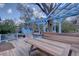 Outdoor living on this backyard deck featuring a pergola, picnic table, grill, and shed for outdoor enjoyment at 7761 S Wellington St, Centennial, CO 80122
