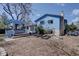 Spacious backyard featuring a beautiful pergola-covered deck with outdoor kitchen, garden beds, and well-manicured lawn at 7761 S Wellington St, Centennial, CO 80122