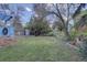 Lush backyard with green grass, various trees, and garden shed for storage at 7761 S Wellington St, Centennial, CO 80122