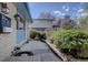 Private backyard featuring a well-kept patio area bordered by mature shrubs and a stone retaining wall at 7761 S Wellington St, Centennial, CO 80122