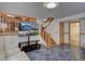 Finished basement featuring a staircase with wooden railing and open access to a bathroom at 7761 S Wellington St, Centennial, CO 80122