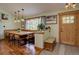 Inviting dining room featuring built-in bench seating, wood floors, and modern pendant lighting at 7761 S Wellington St, Centennial, CO 80122
