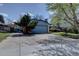 Exterior showing a 2 car garage and ample driveway parking with landscaping features that add to the curb appeal at 7761 S Wellington St, Centennial, CO 80122