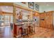 Spacious kitchen with stainless appliances, granite counters, bar seating and access to backyard patio at 7761 S Wellington St, Centennial, CO 80122