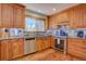 Kitchen featuring stainless steel appliances, wood cabinets, and granite countertops at 7761 S Wellington St, Centennial, CO 80122