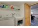 Laundry room with modern appliances and shelving units at 7761 S Wellington St, Centennial, CO 80122