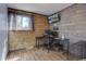 Office space featuring wood paneling, natural light and black desk with mounted monitor at 7761 S Wellington St, Centennial, CO 80122