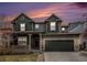 Charming two-story home with a covered front porch, well-maintained lawn, and two-car garage at 2996 Skyward Way, Castle Rock, CO 80109