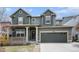 Charming two-story home with a covered front porch, well-maintained lawn, and two-car garage at 2996 Skyward Way, Castle Rock, CO 80109