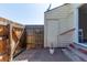 Backyard area featuring a small deck, storage area, and fenced perimeter at 1622 S Idalia Cir # E, Aurora, CO 80017