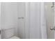 Clean bathroom features a white toilet and shower with white curtain at 1622 S Idalia Cir # E, Aurora, CO 80017