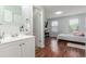 Bathroom with modern vanity and mirror and adjacent bedroom at 1622 S Idalia Cir # E, Aurora, CO 80017