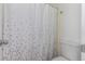 Cozy bathroom featuring a toilet and leaf-patterned shower curtain at 1622 S Idalia Cir # E, Aurora, CO 80017