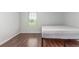 Bright bedroom with a large window with blinds and wood floor at 1622 S Idalia Cir # E, Aurora, CO 80017