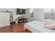 Bedroom with wood floors, two windows with blinds, TV and closet at 1622 S Idalia Cir # E, Aurora, CO 80017