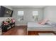 Bedroom with wood floors, two windows with blinds, and TV at 1622 S Idalia Cir # E, Aurora, CO 80017