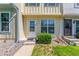 Well-kept townhome with charming front entrance, lawn, and manicured landscaping at 1622 S Idalia Cir # E, Aurora, CO 80017
