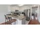 Modern kitchen featuring granite countertops, stainless steel appliances, and seating at the island at 1622 S Idalia Cir # E, Aurora, CO 80017