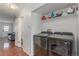 Convenient laundry area with modern washer and dryer units, shelving, and access to other rooms at 1622 S Idalia Cir # E, Aurora, CO 80017