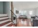 Bright living room with hardwood floors, comfortable seating, and stairway access in the background at 1622 S Idalia Cir # E, Aurora, CO 80017