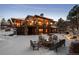 Fire pit seating area in snowy backyard with home view at 10029 Whistling Elk Dr, Littleton, CO 80127